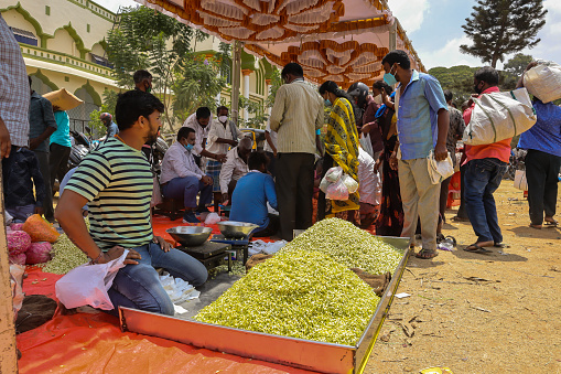 A Flower market scene during midday at Mysuru,Karnataka on the eve of 'Ugadi festival'celebrated across India on a grand scale.