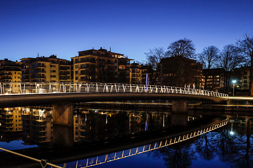 Halmstad, Sweden, A pedestrian bridge over the Nissan river at night.