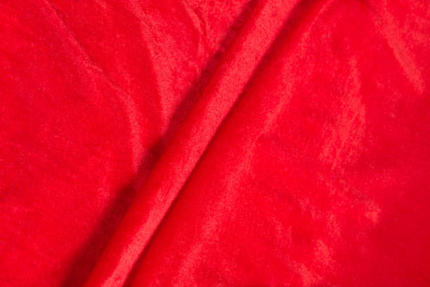 istock Colored red textile satin fabric folded in folds and waves with highlights and texture 1312567665