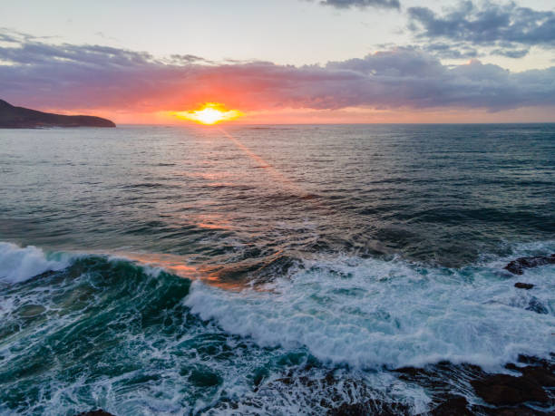 istock Aerial sunrise seascape with waves and clouds 1312568862