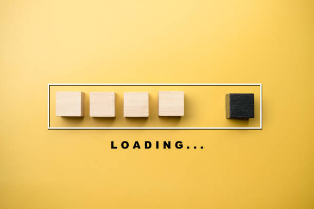 istock Wooden blocks in progress bar with LOADING wording under bar on a yellow background. Loading bar progress and progressive concept 1312571159