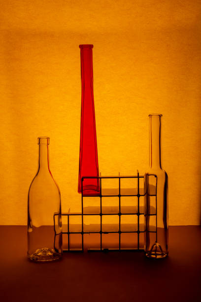 Still life with three glass bottles on a bright background