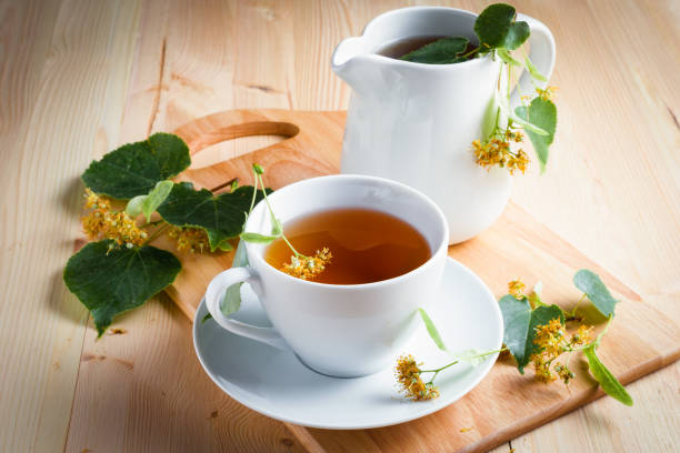 istock A cup with tea, flowers and leaves on a wooden table. 1312573635