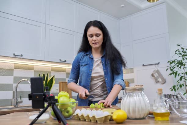 istock Woman recording recipe for making apple pie 1312575644
