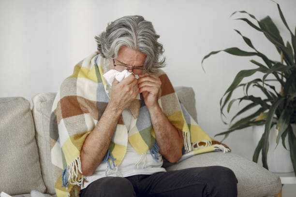 istock Old and sick senior man sitting at home 1312576889