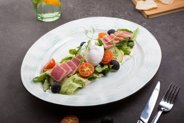 istock Fresh tuna salad served with poached egg on a plate 1312578774