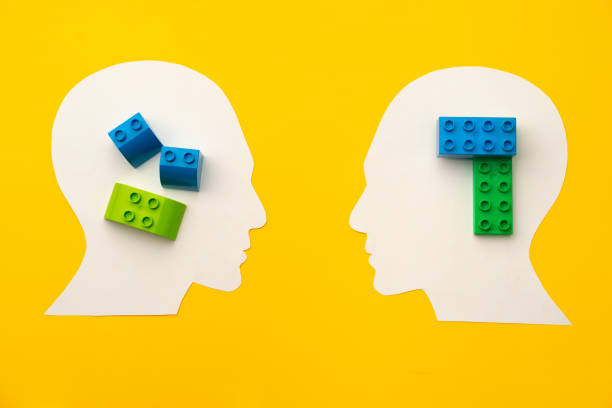 istock Papercut head silhouette with toy constructor pieces on yellow background 1312579821