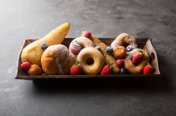 Different types of donuts served with berries