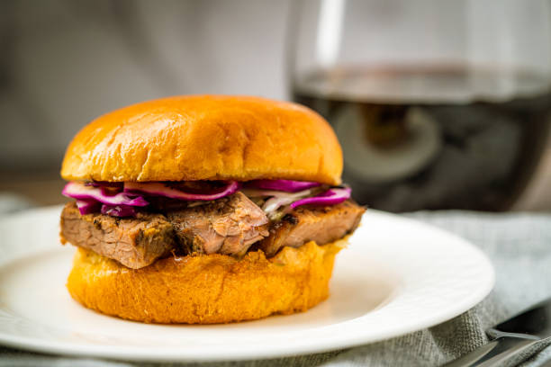 istock Brisket Slider Sandwich Bun on White Plate Red Wine Dinner Lunch Appetizer Meal Texas BBQ Barbecue Barbeque 1312586008
