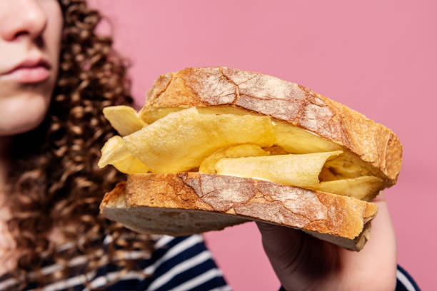 istock Young Woman Holding a Crisp Sandwich 1312586144