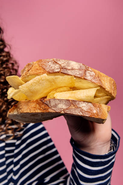 istock Young Woman Holding a Crisp Sandwich 1312586292