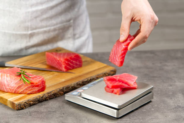 tuna sashimi. Chef weighs the chopped yellowfin tuna. bluefin tuna medallions