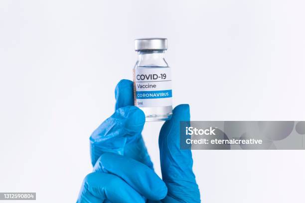 Hand In Protective Glove Holds Covid19 Vaccine Glass Vial Stock Photo - Download Image Now