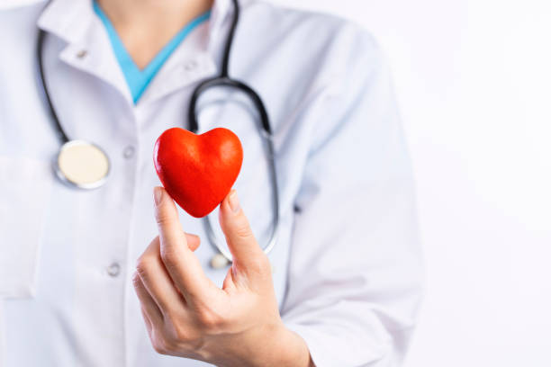 istock Doctor holding red heart shape in hand 1312591028