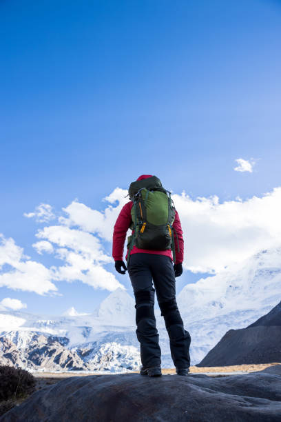 istock Strong woman backpacker hiking in winter mountains 1312592898