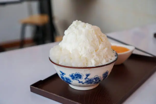 Photo of Milk shaved ice with salted egg. A Taiwanese dessert very popular in Thailand.