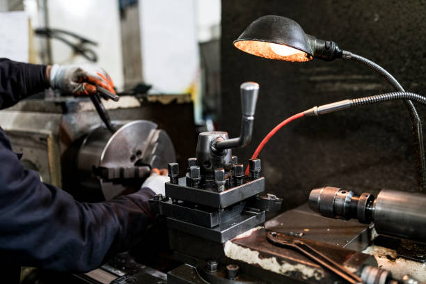 istock A turner grinds a part from an iron rod on a lathe. 1312593963