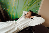 handsome man resting and breathing in deck chair concept relaxation in a spa wellness and care. Side view
