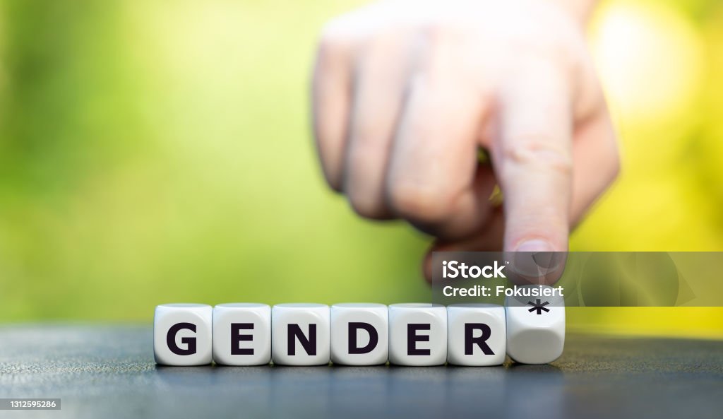 Dice form the expression "gender*" (gender star). A symbol for a gender equitable administrative language in Germany. Text Stock Photo