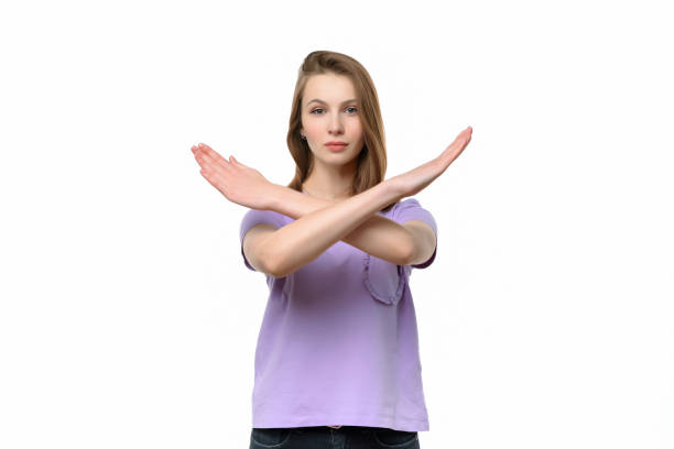 istock Serious young woman keeps two arms crossed, showing stop gesture while looking at camera. Denial concept 1312595656