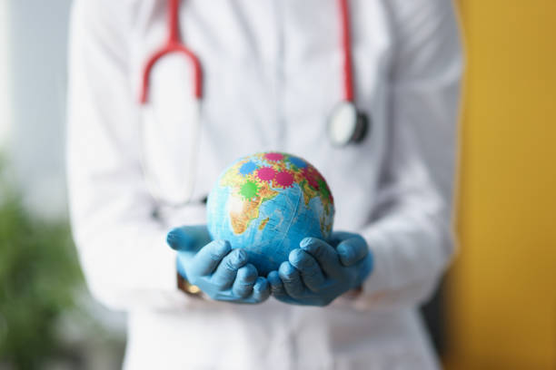 istock Doctor in protective gloves holding globe with viruses closeup 1312596817