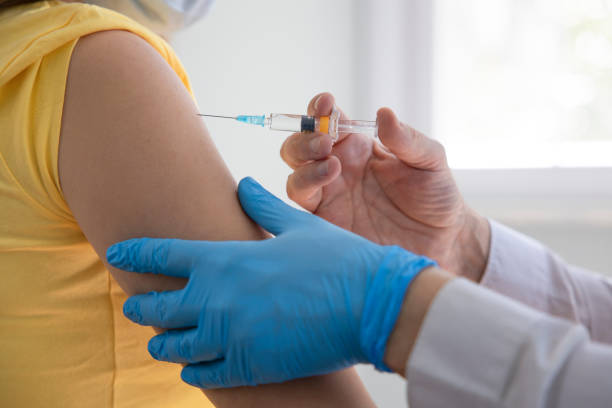 istock Doctor applying a vaccine on a woman's arm 1312598262