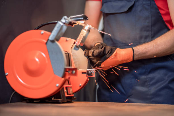 istock Hands of man grinding detail on machine 1312599574