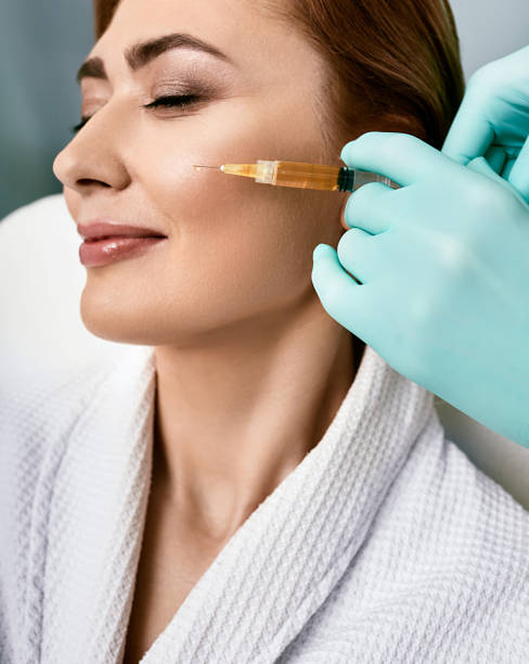 Adult beautiful woman during facial PRP therapy. Blood plasma injection for female facial skin cell restoration Adult beautiful woman during facial PRP therapy. Blood plasma injection for female facial skin cell restoration environmental regeneration photos stock pictures, royalty-free photos & images