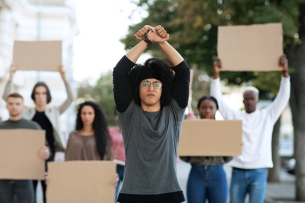 istock Young man activist leading international group of students 1312600244