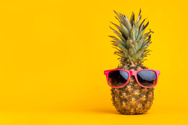 istock Hipster pineapple with sunglasses against yellow 1312600382