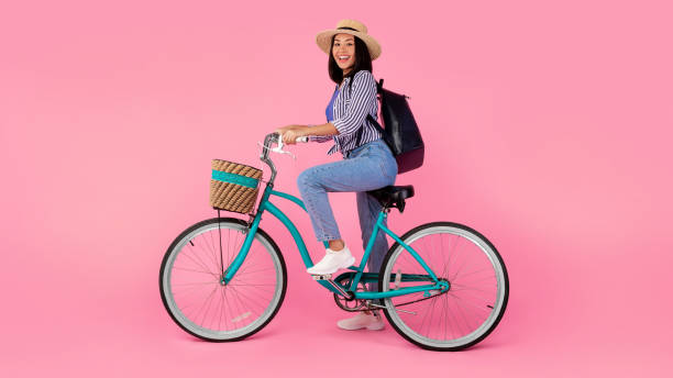 istock Asian lady riding retro bicycle with wicker basket 1312601266