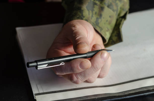 istock The officer's hands are holding a pen, a file folder on a black 1312601555