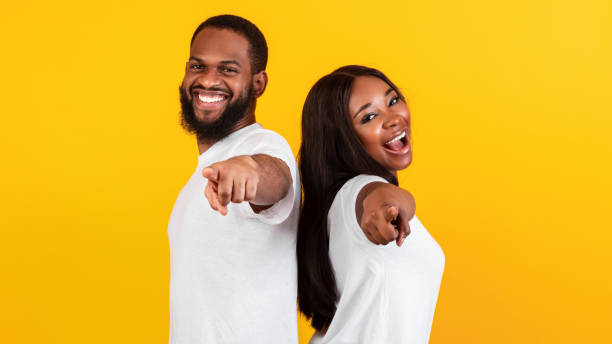 istock Smiling black couple pointing at camera, choosing you 1312603669