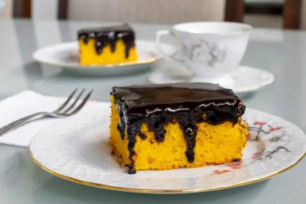 Carrot cake with chocolate icing for afternoon snack. Selective focus