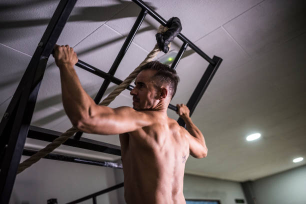 istock Man trains pull-ups in the gym on the power rack without a shirt 1312605162