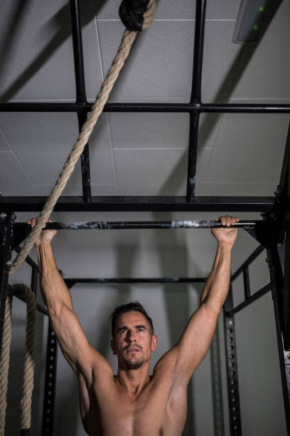 istock Man trains pull-ups in the gym on the power rack without a shirt 1312605163