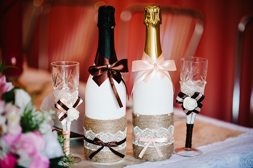 Glasses and a bottle of champagne bride and groom on the festive table newlyweds. happy Wedding day.