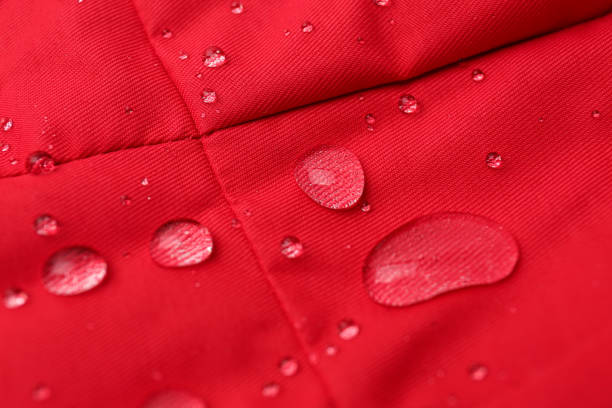 istock Red waterproof fabric with water drops as background, closeup 1312607817