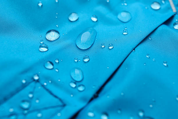istock Light blue waterproof fabric with water drops as background, closeup 1312607863