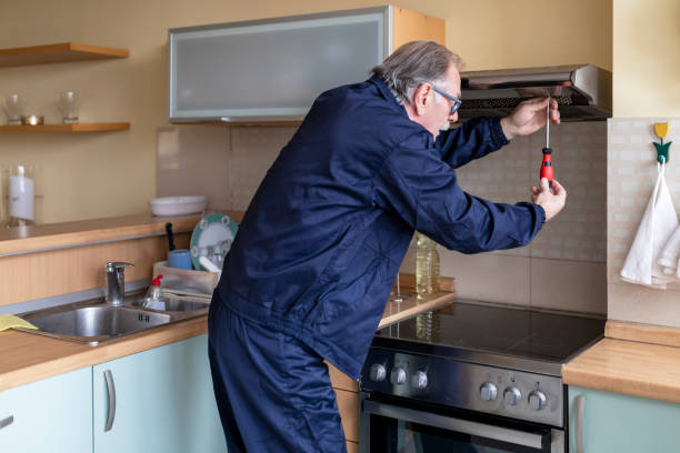 istock Older Man is Working in the Kitchen and Fixing the Extractor Filter. 1312608445