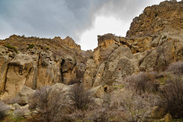 istock Low angle shot of huge yellow cliffs with dramatic dark clouds 1312608589