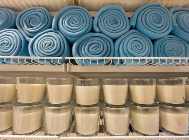 istock Blue blankets and brown candles on a store shelf 1312609421