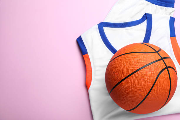 istock Basketball uniform and ball on pink background, top view. Space for text 1312609474