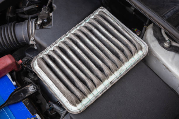 istock Old and dirty car air filters in the engine compartment. 1312609755