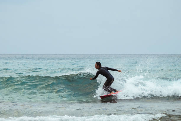 istock Asian man surfing in Taiwan 1312610390