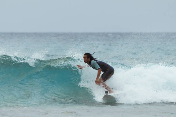 istock Asian man surfing in Taiwan 1312610496