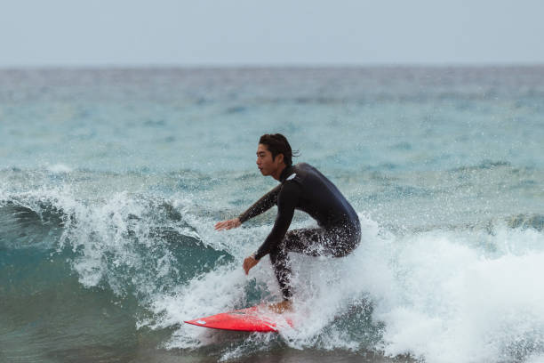 istock Asian man surfing in Taiwan 1312610523