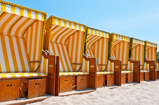 Empty beach chairs are waiting for their guests - Seaside Vacation