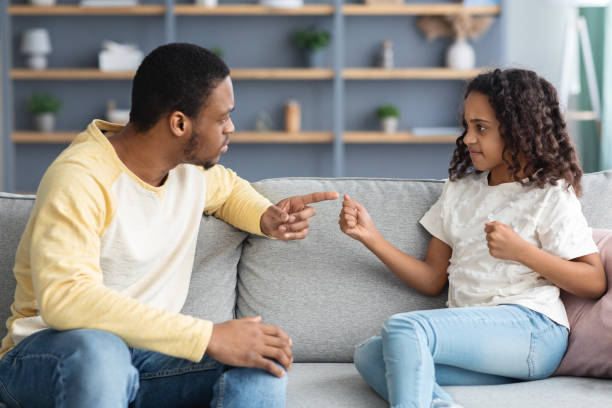 istock Serious black father scolding his angry daughter, home interior 1312613418
