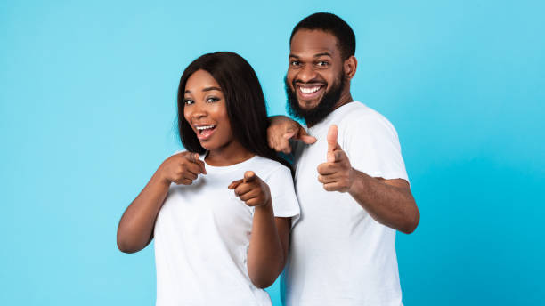 istock Smiling black couple pointing at camera, choosing you 1312613799